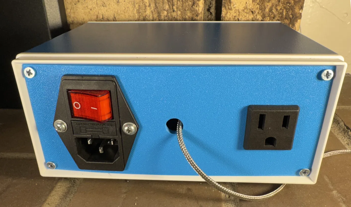 stoveLogic rear panel: IEC power inlet with illuminated red rocker, braided cable grommet, standard 3-prong fan outlet